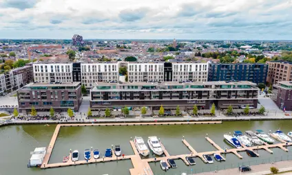 A pleasant walkway along the water, surrounded by architecture, in Quartier Bleu, Hasselt.